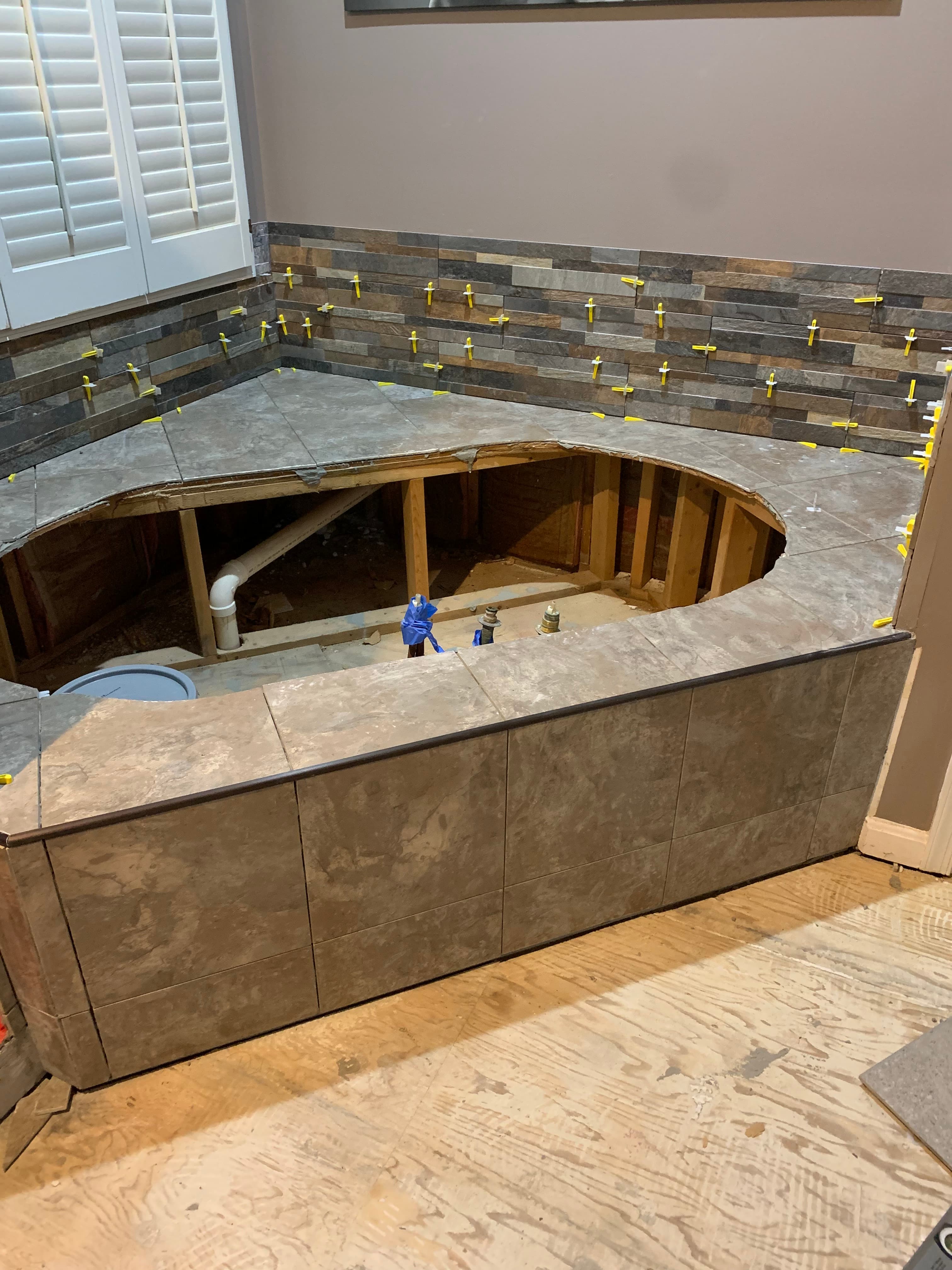 Master bathroom custom tile platform and linear slate backsplash in Maryland by Atlantic Construction