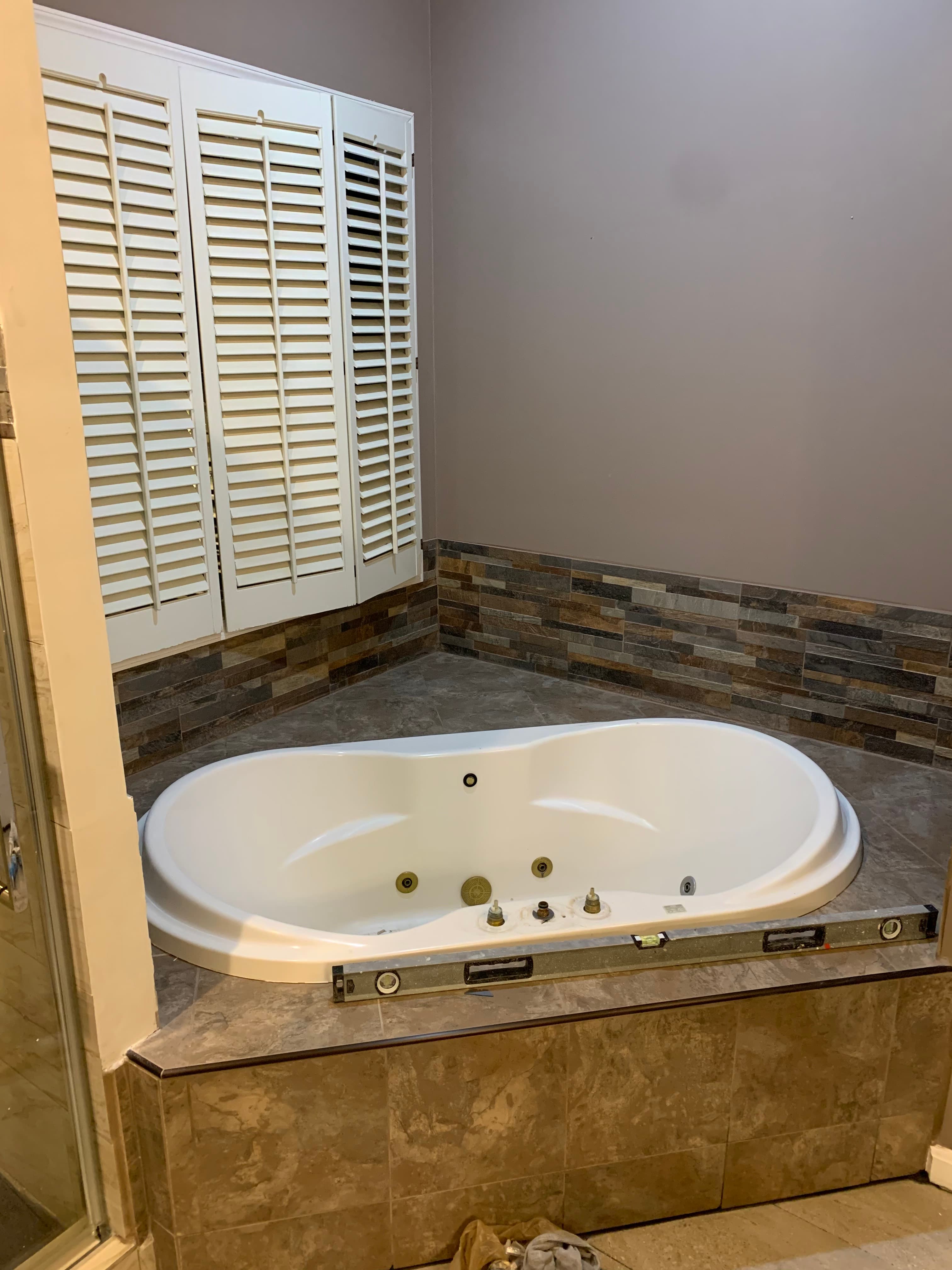 Master bathroom jetted tub installation with plantation shutters in Maryland by Atlantic Construction