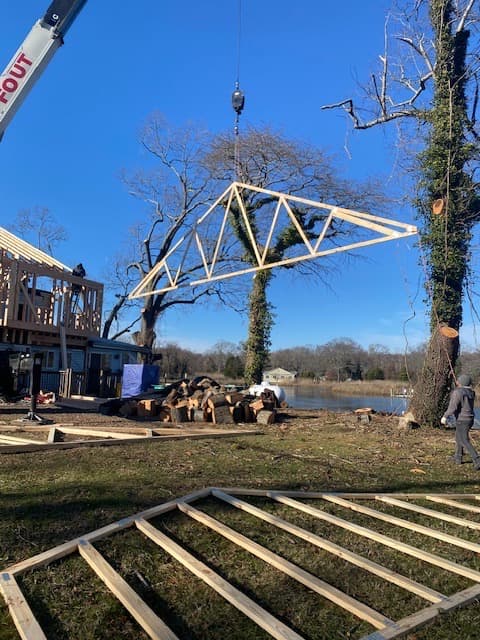Residential new construction timber framing with crane at waterfront property in Maryland by Atlantic Construction