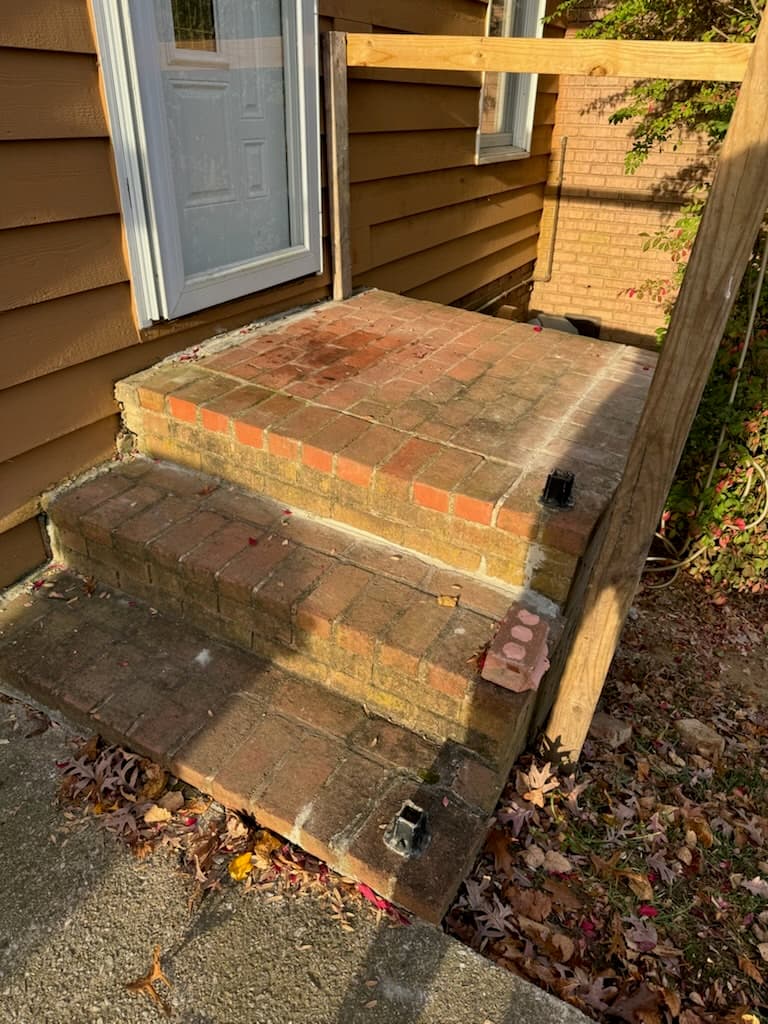 Brick masonry entry steps before repair from ground level in Maryland by Atlantic Construction